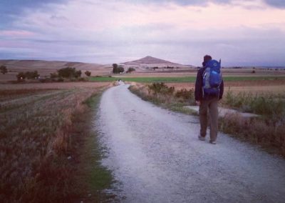 A hiker along the Camino at dawn